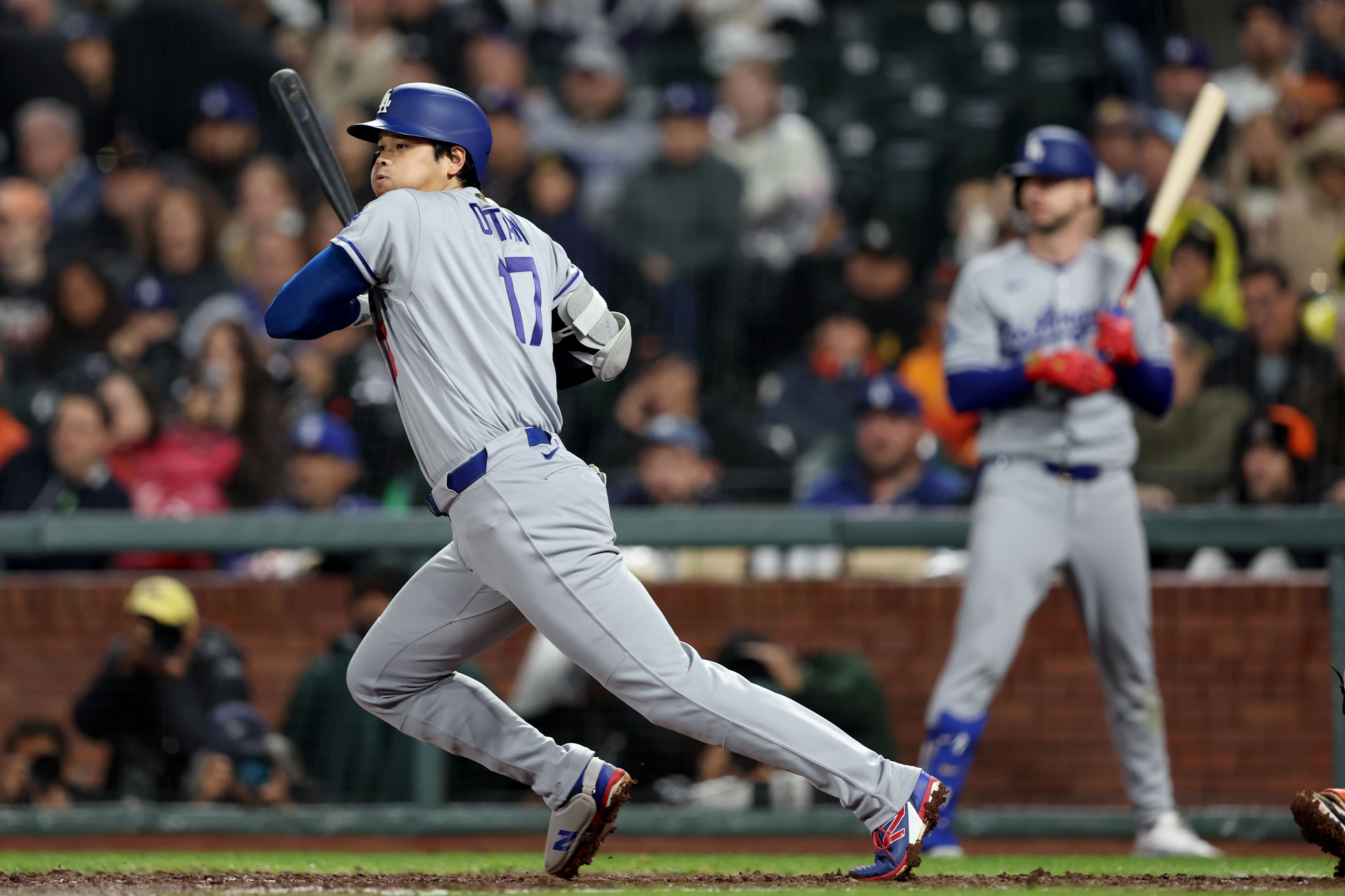 Los Angeles Dodgers’s Shohei Ohtani (17) follows the flight of...