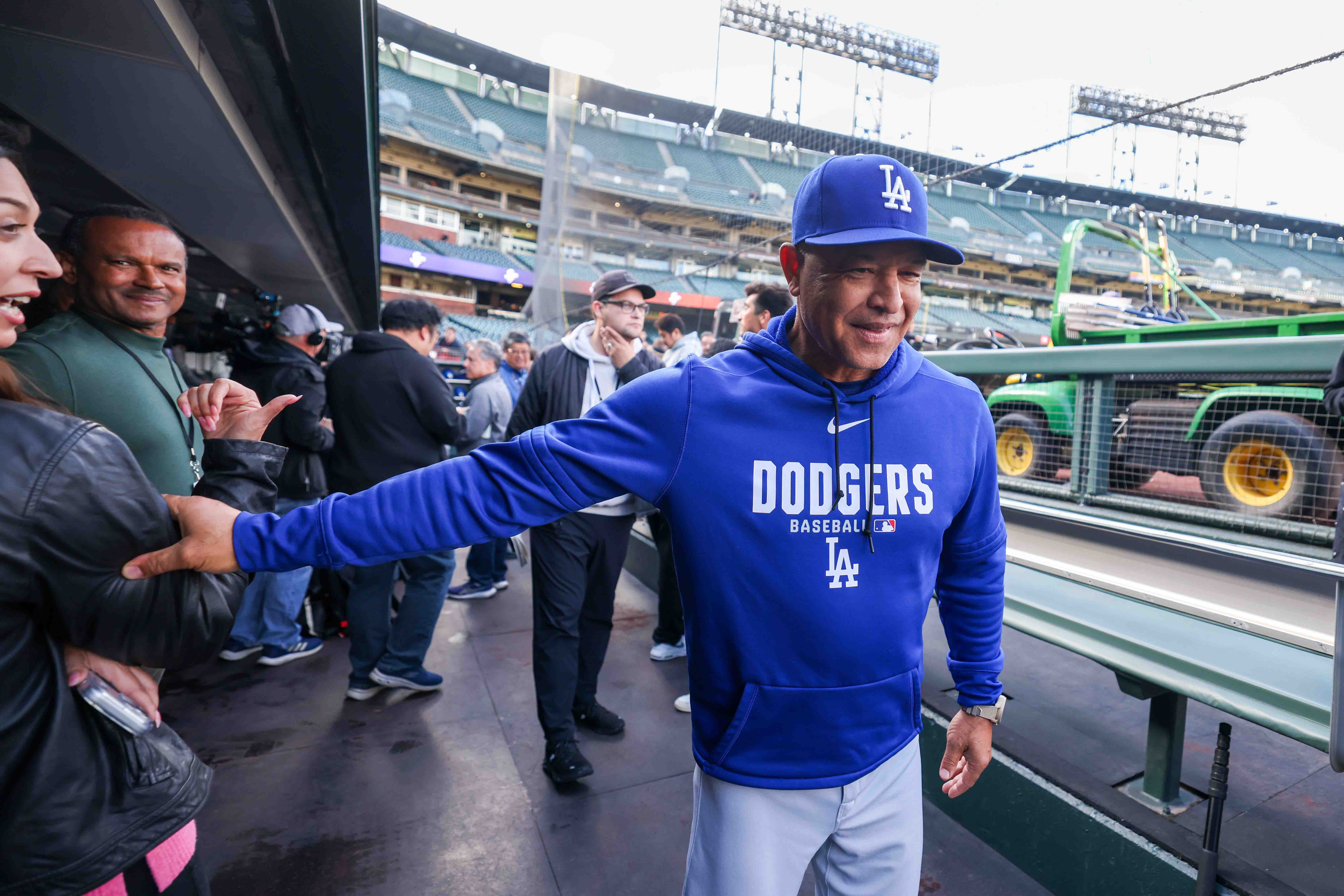 Los Angeles Dodgers manager Dave Roberts reacts in the dugout...