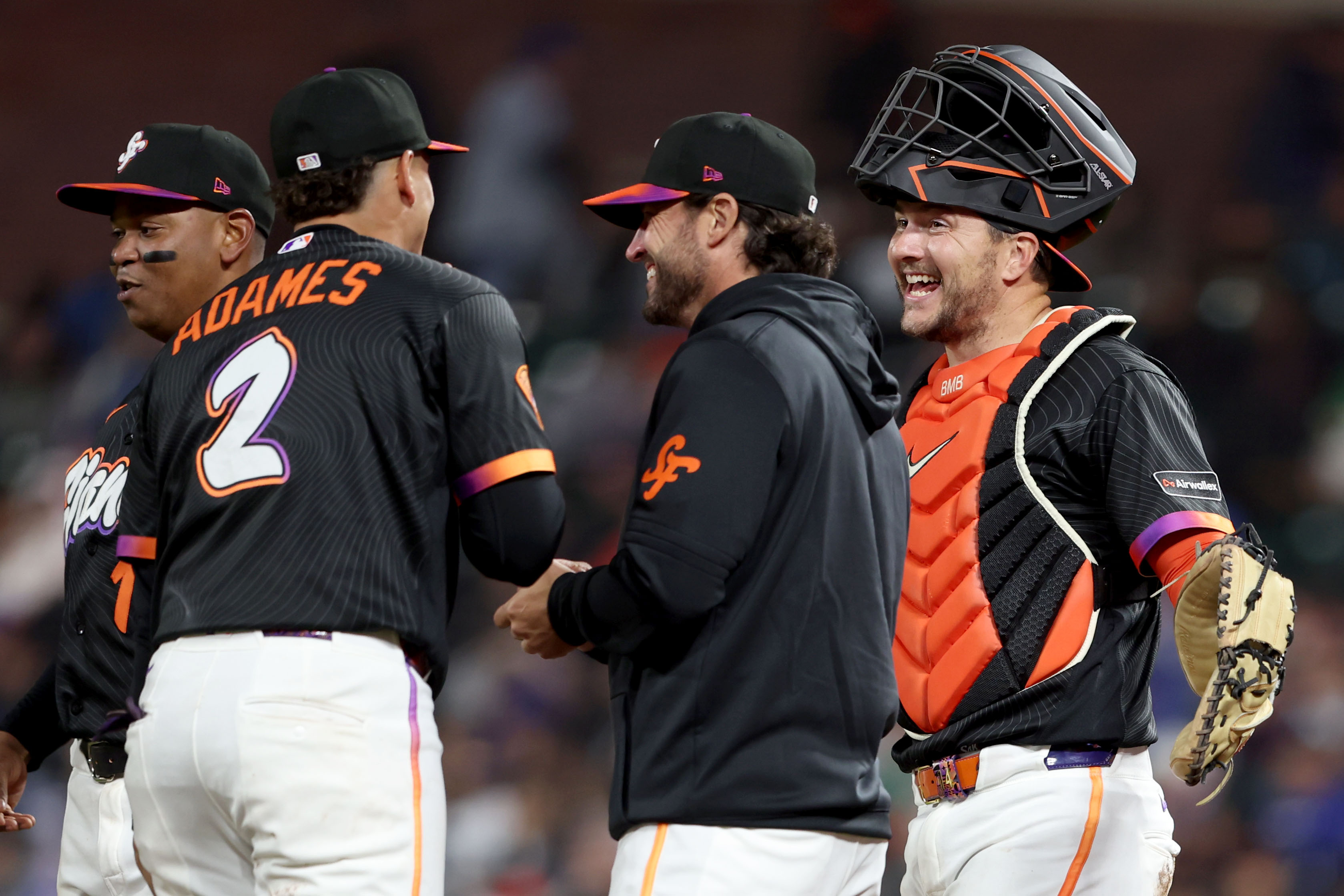 San Francisco Giants manager Tony Vitello, third from left, shares...