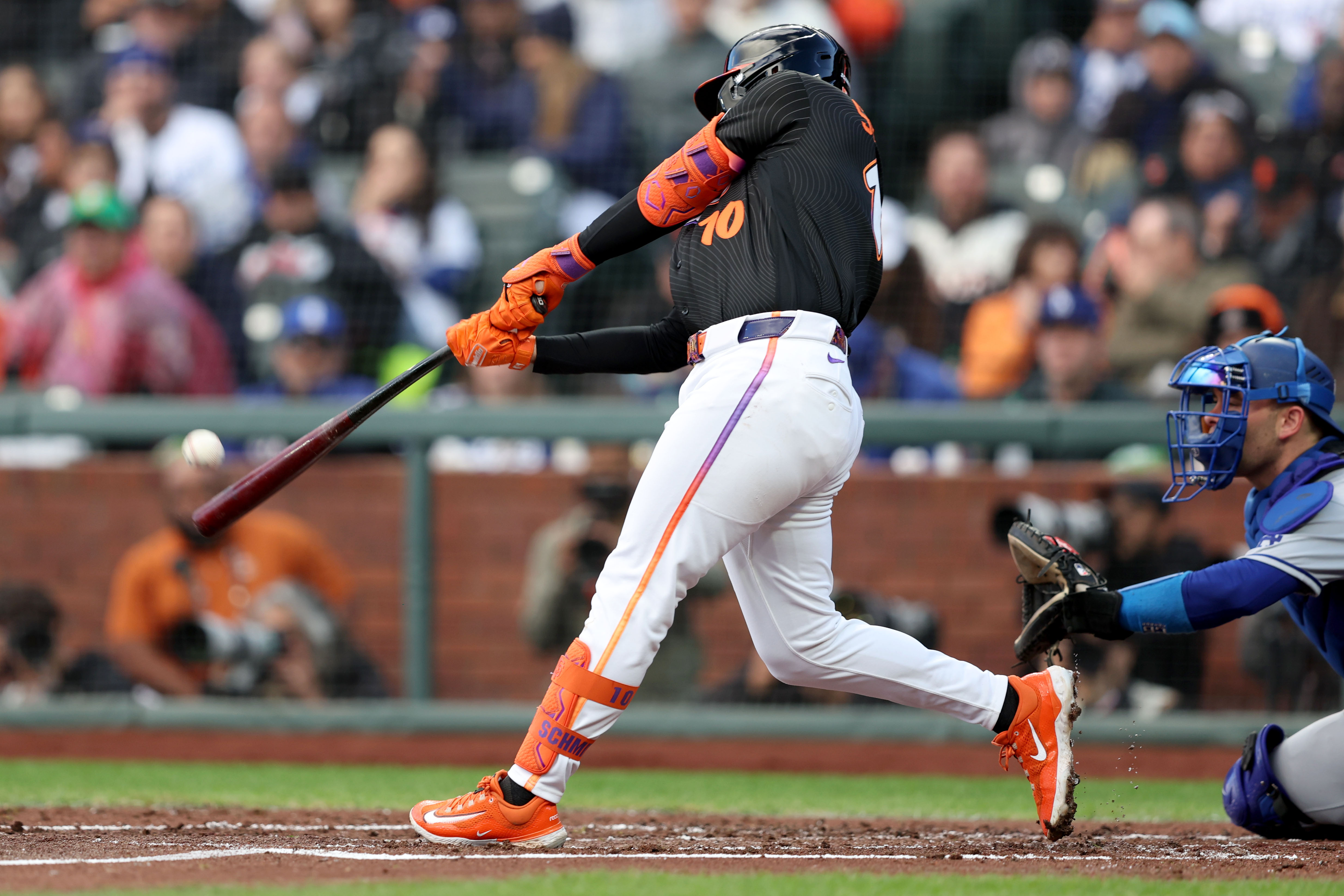 San Francisco Giants’ Casey Schmitt (10) connects a sacrifice fly...