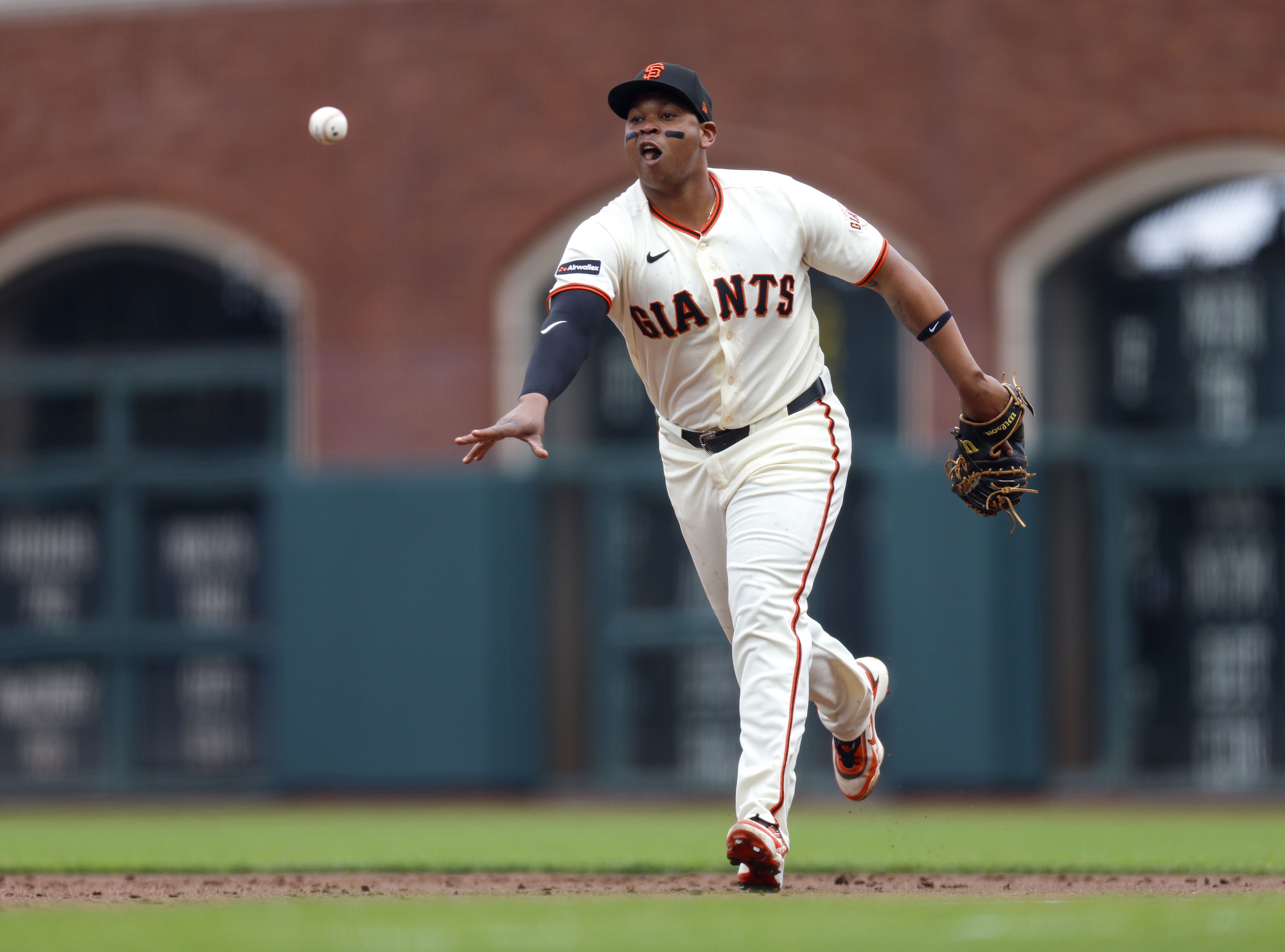 San Francisco Giants’ Rafael Devers (16) tosses the ball to...