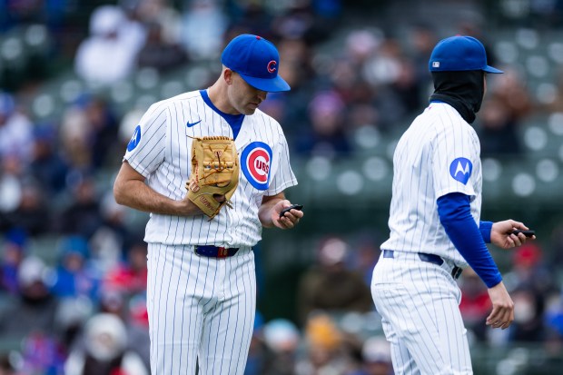 Chicago Cubs pitcher Matthew Boyd (16) has issues with his PitchCom during the third inning of a game against the Los Angeles Angels at Wrigley Field in Chicago on Wednesday, April 1, 2026. (Josh Boland/Chicago Tribune)