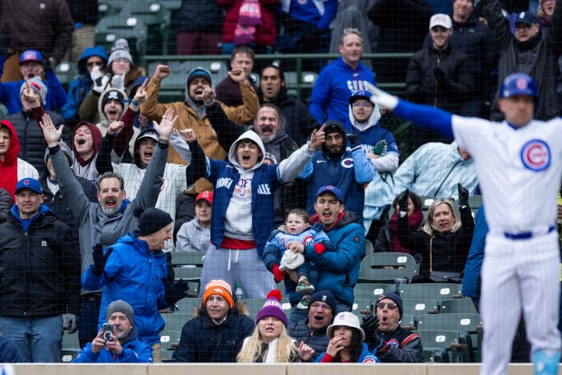 Chicago Cubs fans celebrate a scored run by Chicago Cubs catcher Miguel Amaya during the third inning of a game against the Los Angeles Angels at Wrigley Field in Chicago on Wednesday, April 1, 2026. (Josh Boland/Chicago Tribune)