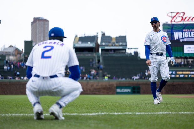 Chicago Cubs second baseman Nico Hoerner (2) and shortstop Dansby Swanson warm up ahead of a game against the Los Angeles Angels at Wrigley Field in Chicago on Wednesday, April 1, 2026. (Josh Boland/Chicago Tribune)