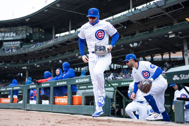 Chicago Cubs left fielder Ian Happ and shortstop Dansby Swanson takes the field during the first inning of a game against the Los Angeles Angels at Wrigley Field in Chicago on Wednesday, April 1, 2026. (Josh Boland/Chicago Tribune)