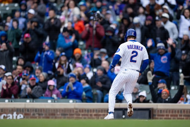 Chicago Cubs second baseman Nico Hoerner (2) runs over home plate scoring a run during the third inning of a game against the Los Angeles Angels at Wrigley Field in Chicago on Wednesday, April 1, 2026. (Josh Boland/Chicago Tribune)