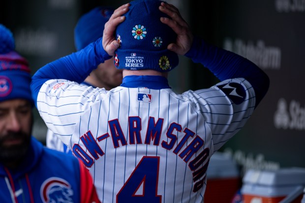 Chicago Cubs center fielder Pete Crow-Armstrong puts on a hat during the fifth inning of a game against the Los Angeles Angels at Wrigley Field in Chicago on Wednesday, April 1, 2026. (Josh Boland/Chicago Tribune)