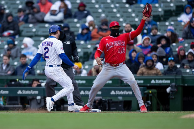 Chicago Cubs second baseman Nico Hoerner (2) touches the bag and is safe at first as Los Angeles first baseman Jeimer Candelario (46) catches a ball during the sixth inning of a game against the Los Angeles Angels at Wrigley Field in Chicago on Wednesday, April 1, 2026. (Josh Boland/Chicago Tribune)