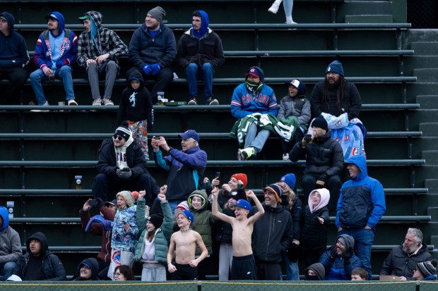 Chicago Cubs fans cheer during the seventh inning of a game against the Los Angeles Angels at Wrigley Field in Chicago on Wednesday, April 1, 2026. (Josh Boland/Chicago Tribune)
