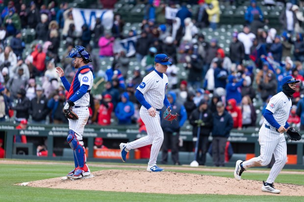 Chicago Cubs catcher Carson Kelly, center fielder Pete Crow-Armstrong and third baseman Matt Shaw run off the field after defeating the Los Angeles Angels at Wrigley Field in Chicago on Wednesday, April 1, 2026. (Josh Boland/Chicago Tribune)