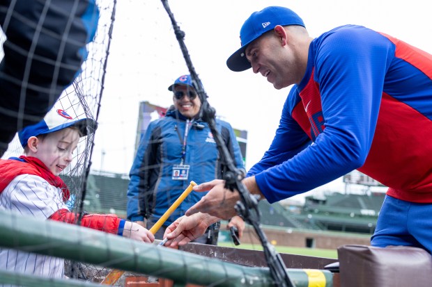 Chicago Cubs pitcher Matthew Boyd signs a bat for a young fan after defeating the Los Angeles Angels at Wrigley Field in Chicago on Wednesday, April 1, 2026. (Josh Boland/Chicago Tribune)