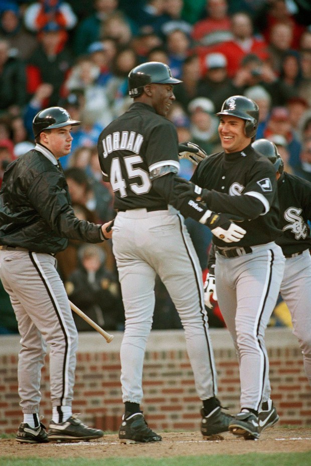 Michael Jordan, left, is congratulated by Chicago White Sox teammate Julio Vinas after he knocked in Jordan on a two-run homer in the sixth inning during the Windy City Classic at Wrigley Field in Chicago, on April 7, 1994. The exhibition game ended in a 4-4 tie in 10 innings. (Mark Elias/AP)