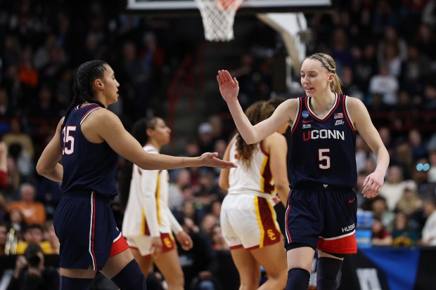 UConn's Azzi Fudd, left, and Paige Bueckers celebrate during an NCAA Tournament Elite Eight game against USC on March 31, 2025, in Spokane, Wash. (Steph Chambers/Getty)