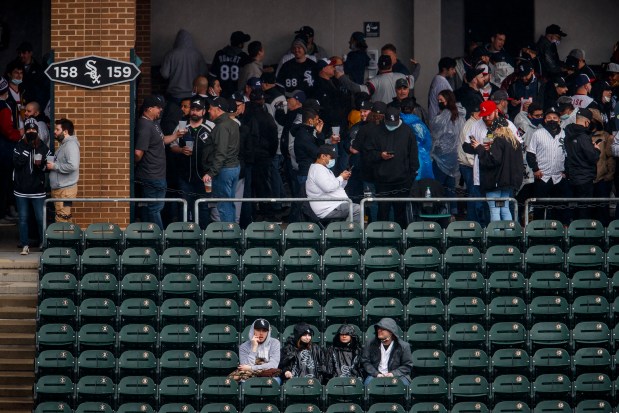 Fans wait out a rain delay before the Chicago White Sox home opener against the Kansas City Royals at Guaranteed Rate Field on April 8, 2021 in Chicago. (Armando L. Sanchez/Chicago Tribune)