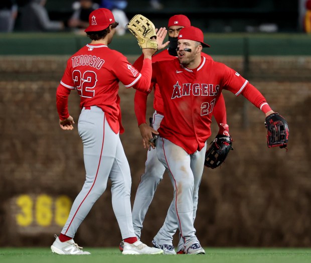 Los Angeles Angels outfielders Bryce Teodosio (22) and Mike Trout (27) celebrate after beating the Chicago Cubs at Wrigley Field in Chicago on March 31, 2026. (Chris Sweda/Chicago Tribune)