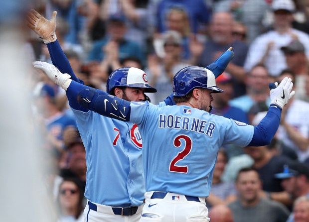 Chicago Cubs second baseman Nico Hoerner (2) celebrates with teammate Dansby Swanson (7) after Hoerner hit a two-run home run in the second inning of a game against the New York Mets at Wrigley Field in Chicago on April 17, 2026. (Chris Sweda/Chicago Tribune)