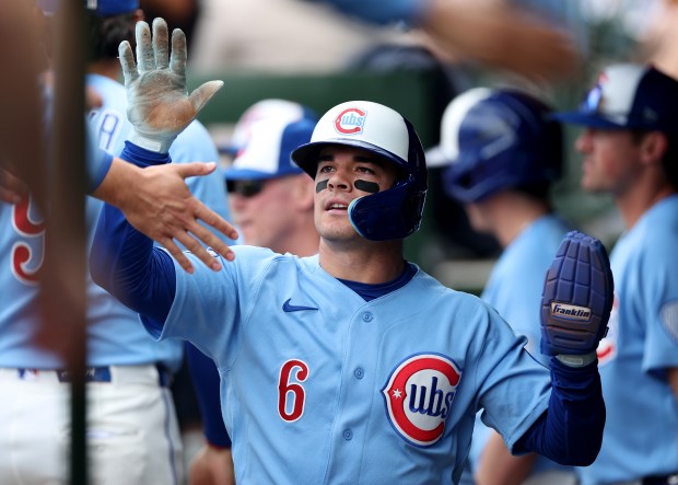 Chicago Cubs designated hitter Matt Shaw (6) is congratulated by his teammates after scoring on a wild pitch in the seventh inning of a game against the New York Mets at Wrigley Field in Chicago on April 17, 2026. (Chris Sweda/Chicago Tribune)