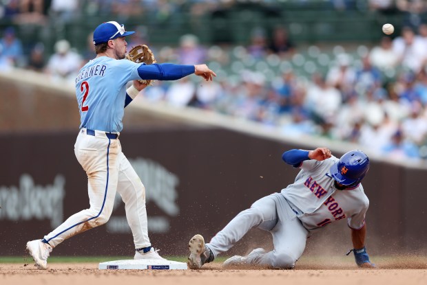 Chicago Cubs second baseman Nico Hoerner makes a throw to first base to complete a double play after forcing out New York Mets second baseman Marcus Semien at second base in the eighth inning of a game at Wrigley Field in Chicago on April 17, 2026. (Chris Sweda/Chicago Tribune)