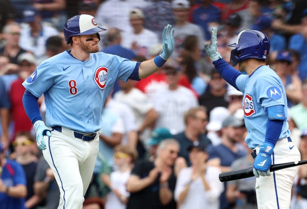 Chicago Cubs left fielder Ian Happ (8) is congratulated after hitting a solo home run in the eighth inning of a game against the New York Mets at Wrigley Field in Chicago on April 17, 2026. (Chris Sweda/Chicago Tribune)