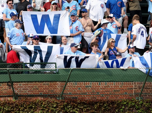Chicago Cubs fans in the left field bleachers display their W flags after a Cubs victory over the New York Mets at Wrigley Field in Chicago on April 17, 2026. (Chris Sweda/Chicago Tribune)