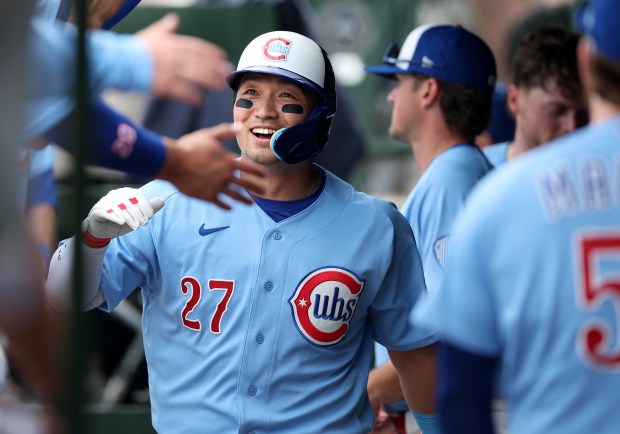 Chicago Cubs right fielder Seiya Suzuki is congratulated in the dugout after scoring on a double by teammate Matt Shaw in the seventh inning of a game against the New York Mets at Wrigley Field in Chicago on April 17, 2026. (Chris Sweda/Chicago Tribune)