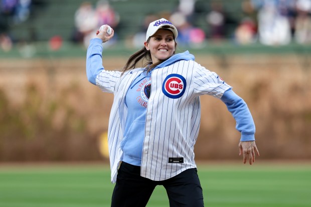 Former Chicago Sky guard Allie Quigley throws out the first pitch before the Cubs play the Phillies at Wrigley Field April 20, 2026, in Chicago. (Armando L. Sanchez/Chicago Tribune)