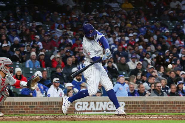 Cubs shortstop Dansby Swanson hits a three-run home run during the second inning against the Phillies at Wrigley Field on April 20, 2026, in Chicago. (Armando L. Sanchez/Chicago Tribune)