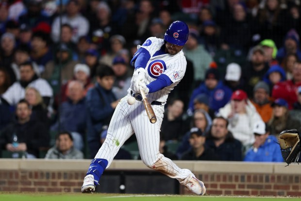 Cubs left fielder Michael Conforto (20) hits a sacrifice fly bringing in Cubs first baseman Michael Busch (29) during the third inning at Wrigley Field April 20, 2026, in Chicago. (Armando L. Sanchez/Chicago Tribune)