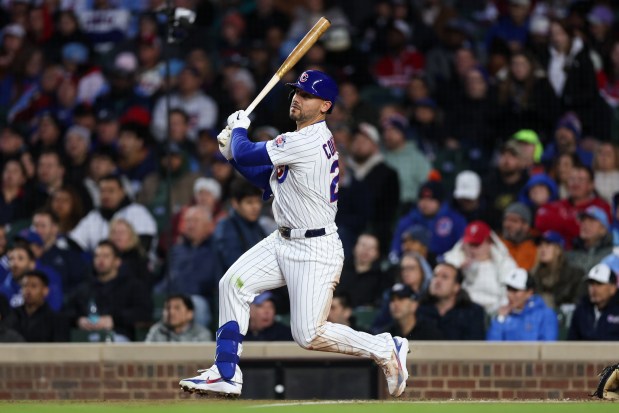 Cubs left fielder Michael Conforto (20) hits a sacrifice fly bringing in Cubs first baseman Michael Busch (29) during the third inning at Wrigley Field April 20, 2026, in Chicago. (Armando L. Sanchez/Chicago Tribune)