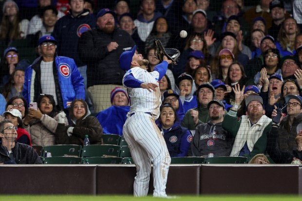 Cubs first baseman Michael Busch (29) misses a foul ball from Phillies right fielder Adolis García (53) during the fifth inning at Wrigley Field April 20, 2026, in Chicago. (Armando L. Sanchez/Chicago Tribune)