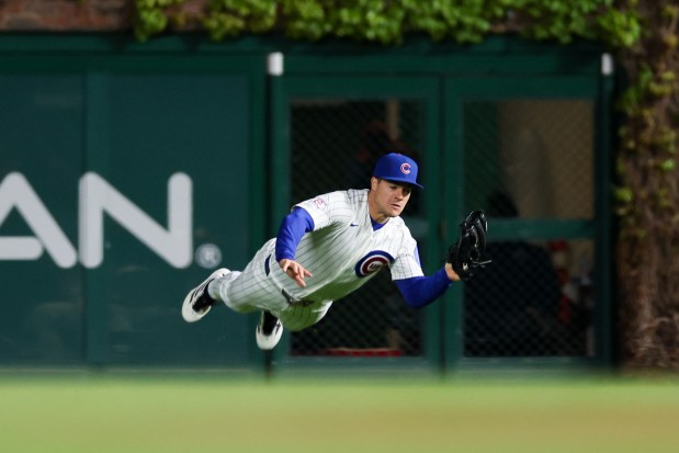 Cubs third baseman Matt Shaw (6) falls on the field after catching a ball from Phillies shortstop Trea Turner (7) during the ninth inning at Wrigley Field April 20, 2026, in Chicago. (Armando L. Sanchez/Chicago Tribune)