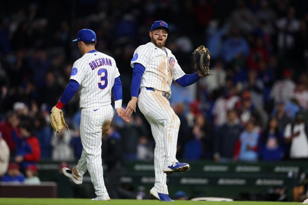 Cubs third baseman Alex Bregman (3) and Cubs first baseman Michael Busch (29) celebrate after the Cubs defeated the Phillies, 5-1, at Wrigley Field April 20, 2026, in Chicago. (Armando L. Sanchez/Chicago Tribune)