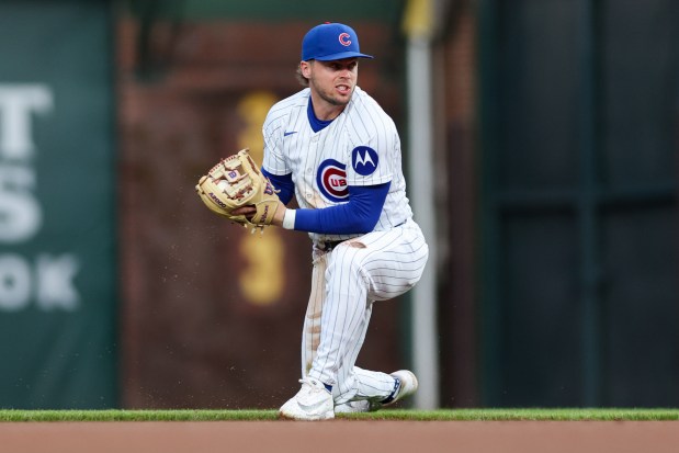 Cubs second baseman Nico Hoerner (2) fields a ball from Phillies first baseman Bryce Harper (3) during the first inning at Wrigley Field April 20, 2026, in Chicago. (Armando L. Sanchez/Chicago Tribune)