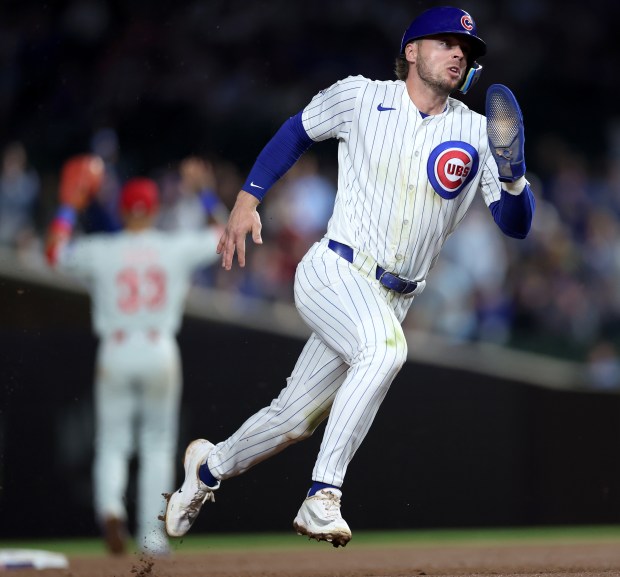 Chicago Cubs second baseman Nico Hoerner sprints around the bases as he advances to third base on a single by teammate Ian Happ in the sixth inning of a game against the Philadelphia Phillies at Wrigley Field in Chicago on April 21, 2026. (Chris Sweda/Chicago Tribune)