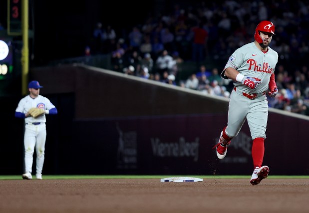 Philadelphia Phillies designated hitter Kyle Schwarber (12) rounds the bases after hitting a solo home run in the sixth inning of a game against the Chicago Cubs at Wrigley Field in Chicago on April 21, 2026. (Chris Sweda/Chicago Tribune)