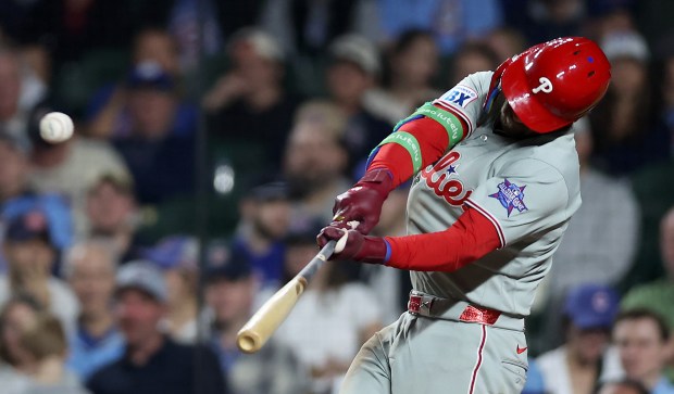 Philadelphia Phillies first baseman Bryce Harper (3) hits a two-run home run in the eighth inning of a game against the Chicago Cubs at Wrigley Field in Chicago on April 21, 2026. (Chris Sweda/Chicago Tribune)