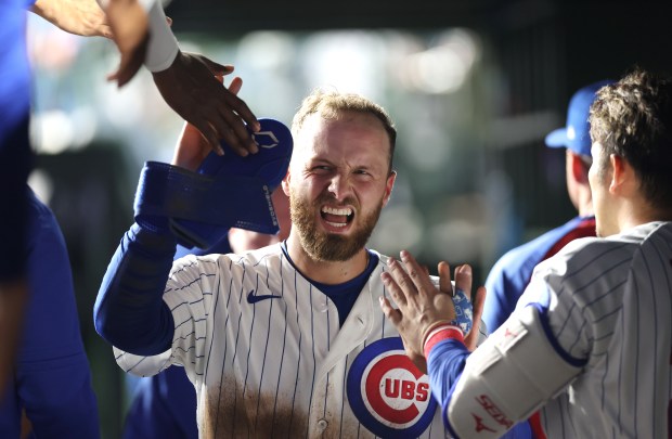 Chicago Cubs first baseman Michael Busch is congratulated in the dugout after scoring on a wild pitch in the eighth inning of a game against the Philadelphia Phillies at Wrigley Field in Chicago on April 21, 2026. (Chris Sweda/Chicago Tribune)