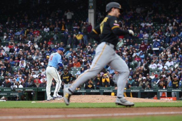 Chicago Cubs relief pitcher Caleb Thielbar stands on the edge of the mound as Pittsburgh Pirates left fielder Bryan Reynolds rounds the bases after hitting a two-run home run in the seventh inning of a game at Wrigley Field in Chicago on April 10, 2026. (Chris Sweda/Chicago Tribune)