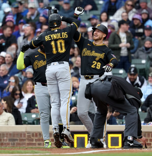 Pittsburgh Pirates left fielder Bryan Reynolds (10) celebrates with teammate Ryan O'Hearn (29) after Reynolds hit a two-run home run in the seventh inning of a game against the Chicago Cubs at Wrigley Field in Chicago on April 10, 2026. (Chris Sweda/Chicago Tribune)