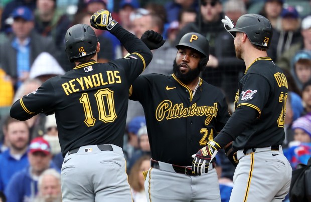 Pittsburgh Pirates left fielder Bryan Reynolds (10) celebrates with teammates Marcell Ozuna (center) and Ryan O'Hearn (right) after Reynolds hit a two-run home run in the seventh inning of a game against the Chicago Cubs at Wrigley Field in Chicago on April 10, 2026. (Chris Sweda/Chicago Tribune)