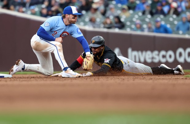 Pittsburgh Pirates center fielder Oneil Cruz steals second base as Chicago Cubs second baseman Nico Hoerner applies a late tag in the seventh inning of a game at Wrigley Field in Chicago on April 10, 2026. (Chris Sweda/Chicago Tribune)
