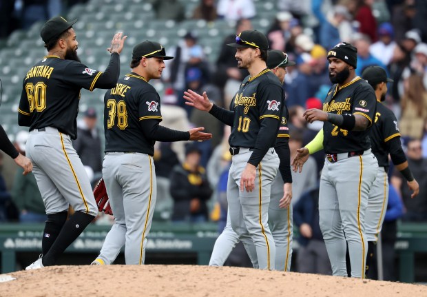 Pittsburgh Pirates players Dennis Santana (60), Nick Yorke (38), Bryan Reynolds (10), and Marcell Ozuna (24), celebrate after their victory over the Chicago Cubs at Wrigley Field in Chicago on April 10, 2026. (Chris Sweda/Chicago Tribune)