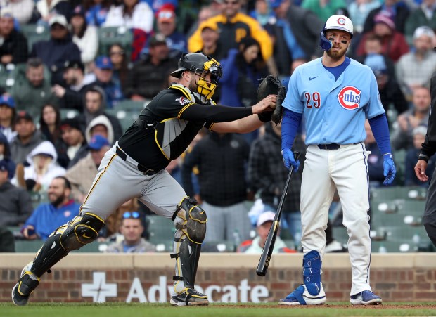 Pittsburgh Pirates catcher Joey Bart tags out Chicago Cubs first baseman Michael Busch (29) on a dropped third strike to secure a Pirates victory in the ninth inning of a game at Wrigley Field in Chicago on April 10, 2026. (Chris Sweda/Chicago Tribune)