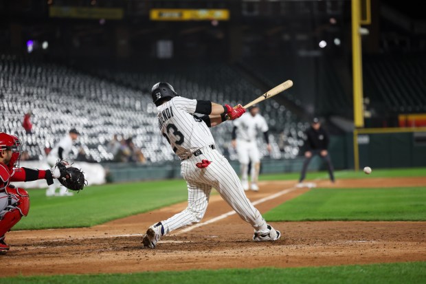 White Sox left fielder Andrew Benintendi (23) hits a RBI single during the fifth inning against the Angels at Rate Field April 27, 2026, in Chicago. (Armando L. Sanchez/Chicago Tribune)