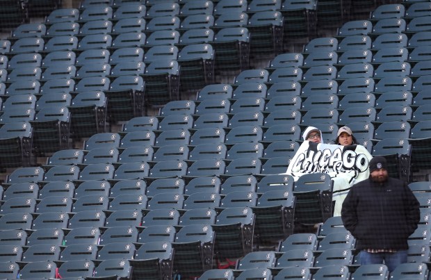 Two fans try to keep warm under a blanket in the fourth inning of a game between the Chicago White Sox and the Baltimore Orioles at Rate Field in Chicago on April 7, 2026. (Chris Sweda/Chicago Tribune)
