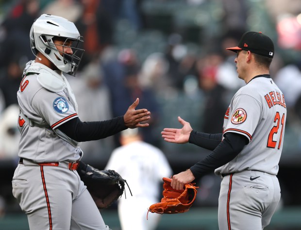 Baltimore Orioles catcher Samuel Basallo (29) and Baltimore Orioles pitcher Ryan Helsley (21) congratulate one another after securing a victory by closing out the Chicago White Sox in the ninth inning of a game at Rate Field in Chicago on April 7, 2026. (Chris Sweda/Chicago Tribune)