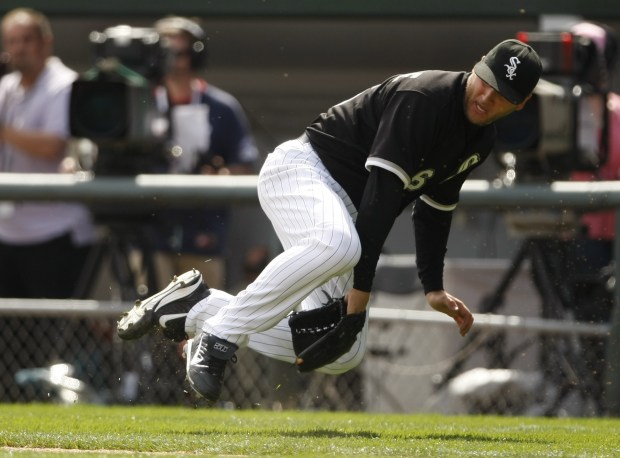 Mark Buehrle flips the ball backward between his legs to throw out Cleveland Indians' Lou Marson at first base in the fith inning on MLB Opening Day at US Cellular Field on April 5, 2010. (Scott Strazzante/Chicago Tribune)