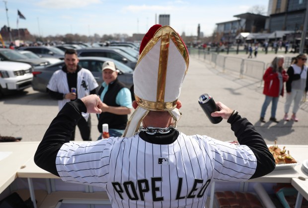 Dan Kozlowski flexes for fellow tailgaters in his Pope Leo jersey and mitre before the White Sox home opener against the Blue Jays at Rate Field on April 3, 2026, in Chicago. (John J. Kim/Chicago Tribune)