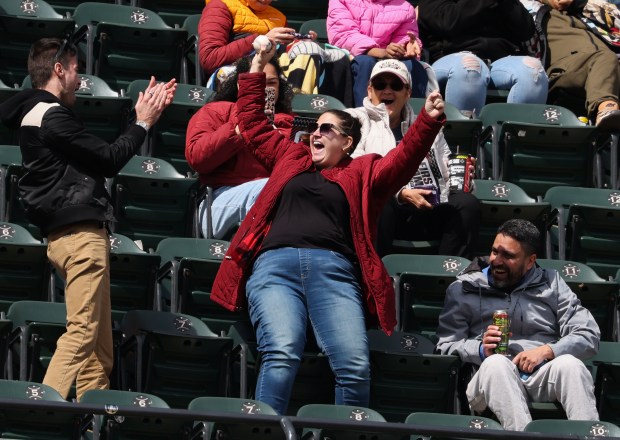 A fan celebrates after catching a foul ball in the fifth inning of a White Sox-Orioles game at Rate Field on April 8, 2026, in Chicago. (John J. Kim/Chicago Tribune)