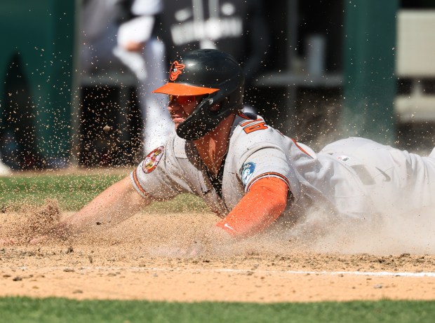 Orioles designated hitter Pete Alonso slides home on a passed ball in the sixth inning against the White Sox at Rate Field on April 8, 2026, in Chicago. (John J. Kim/Chicago Tribune)